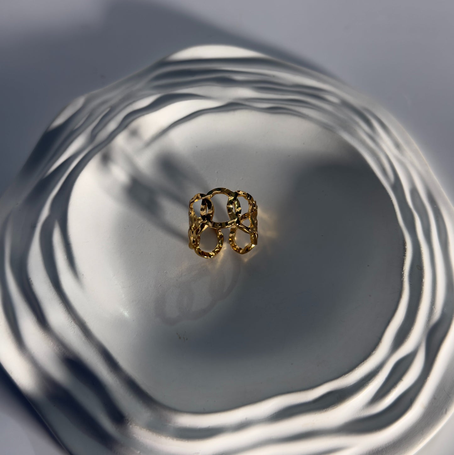 Gold ring on a reflective surface with concentric circles