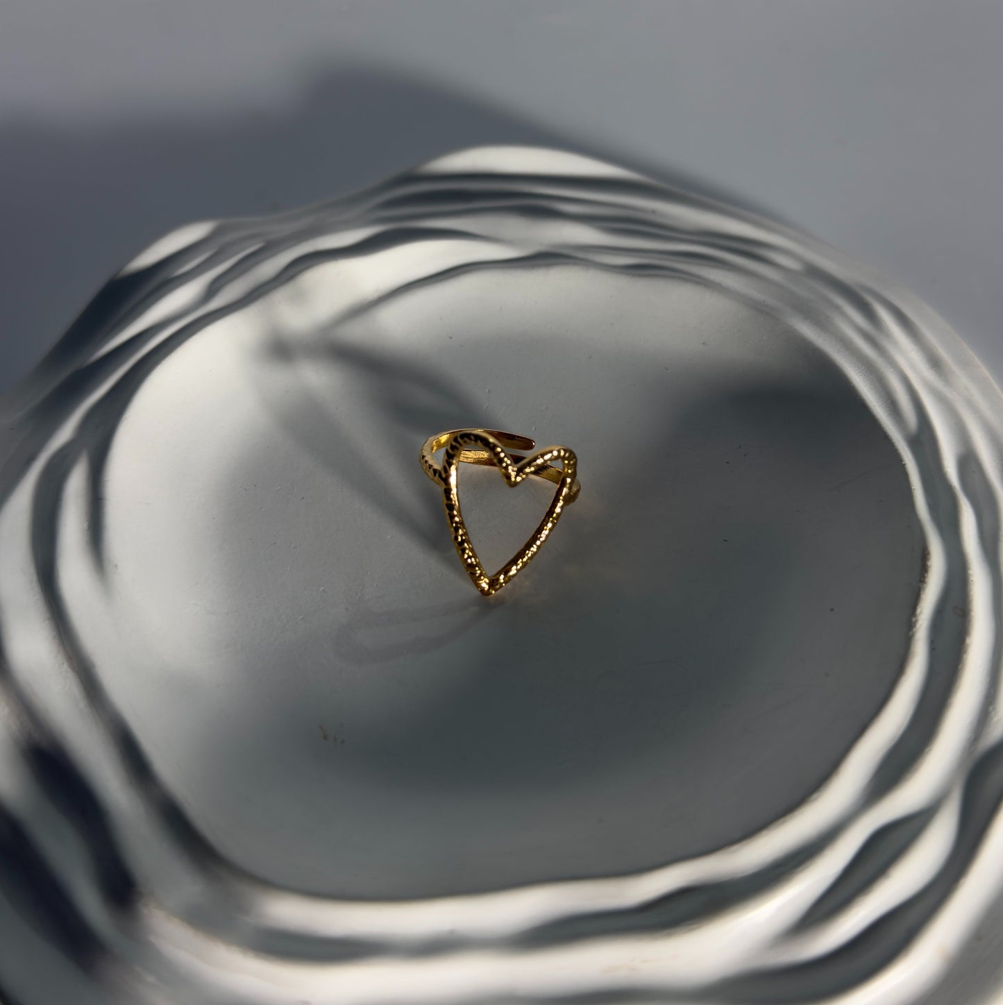Gold ring on a reflective surface with concentric circles