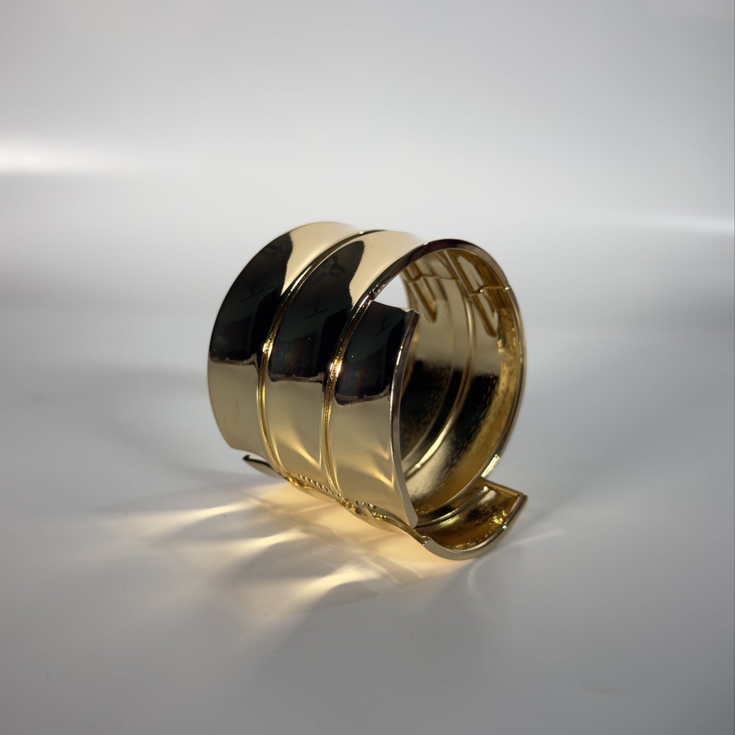 Gold bracelet on a gray background