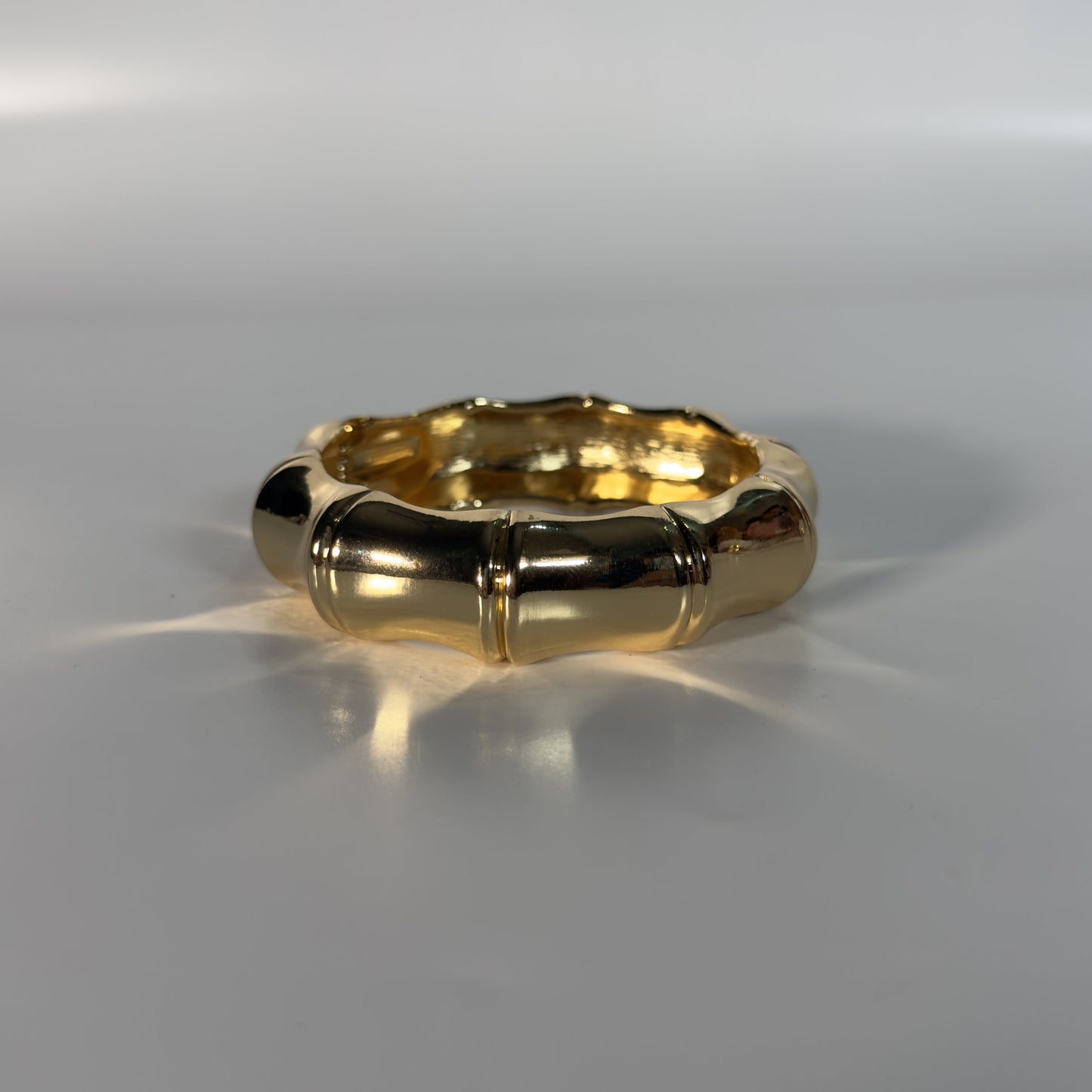 Gold ring on a reflective gray surface