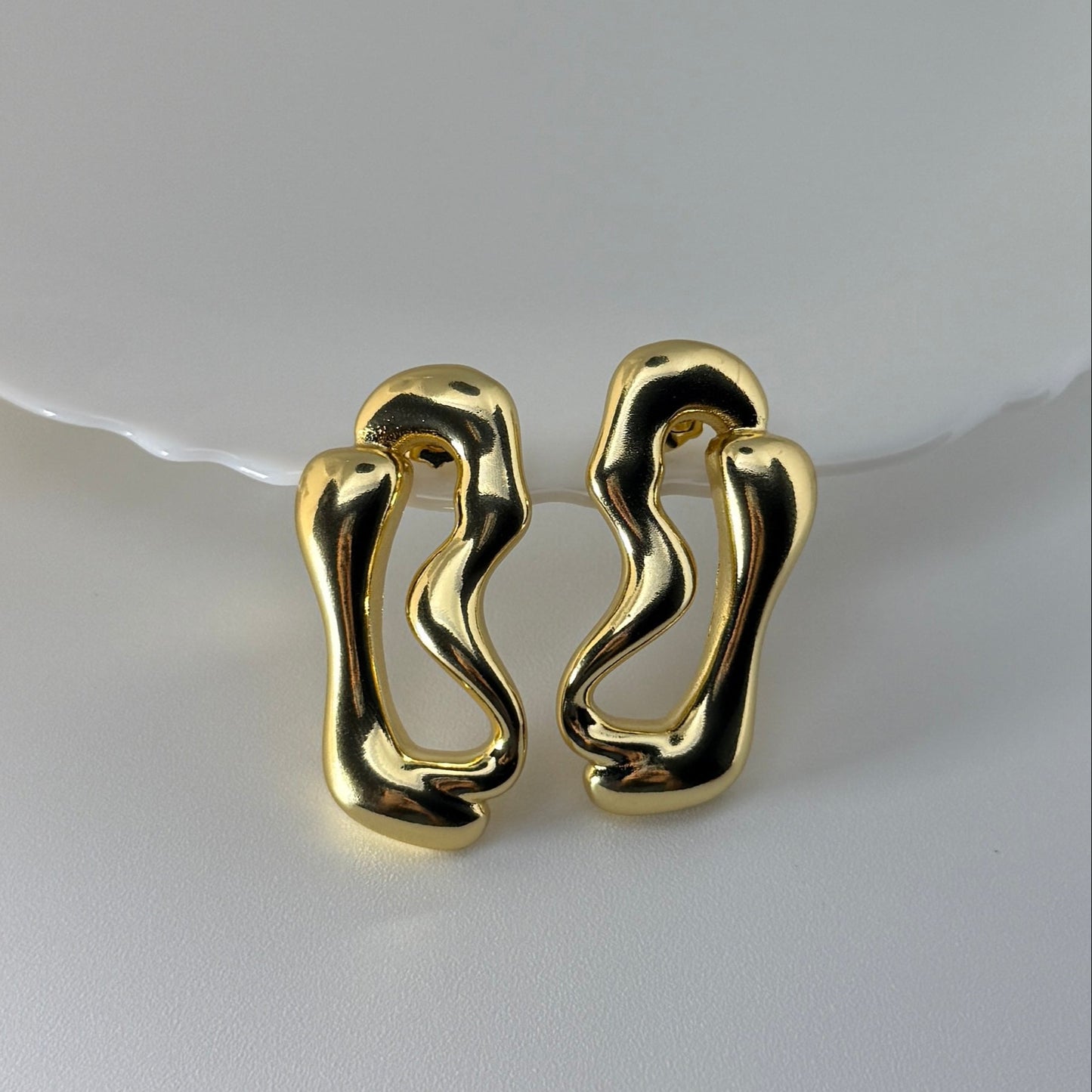 Pair of gold earrings on a white background