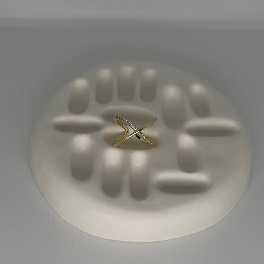 Gold ring on a white abstract sculpture