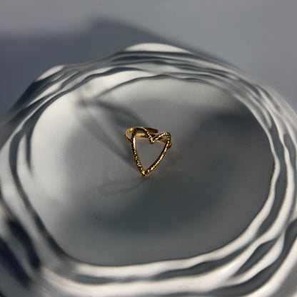 Gold ring on a reflective surface with concentric circles