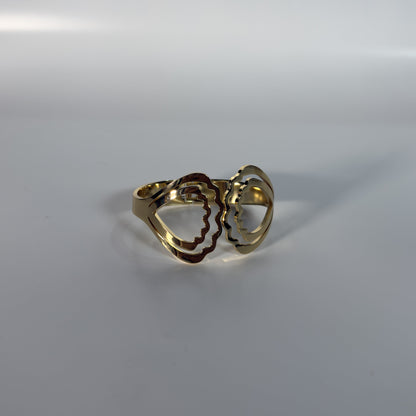 Gold ring with a heart design on a white background