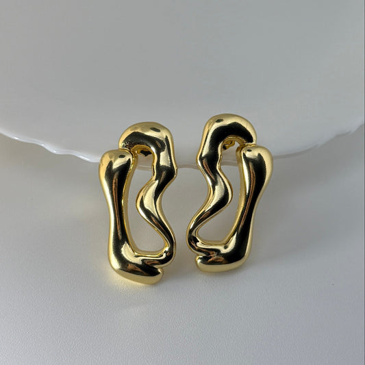 Pair of gold earrings on a white background