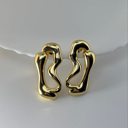 Pair of gold earrings on a white background